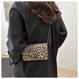 Chic leopard print crossbody bag with gold chain strap on a black blazer outfit