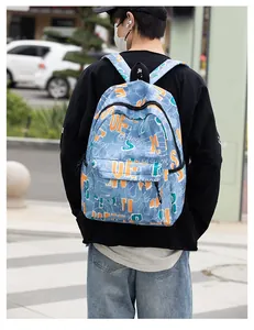 Detail of blue graffiti fashion backpack featuring bold lettering and street style design