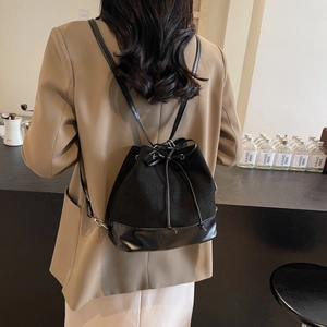 Minimalist black velvet drawstring bucket backpack with premium leather stitching