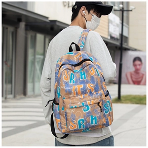 Close-up of graffiti print backpack in khaki with large fashion lettering and front zipper