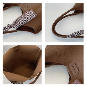 Detail view of brown pebbled leather tote bag with silk scarf handle and magnetic closure
