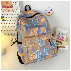 Detail of khaki graffiti backpack showing orange and blue lettering with zipper pocket