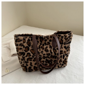 Close-up of leopard print plush tote bag with soft faux fur texture and dark brown straps