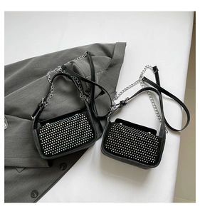 Detail of black crossbody bags with colorful and silver rhinestones on the flap