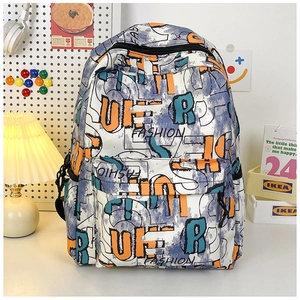 Close-up of graffiti cartoon print backpack with side pockets on a desk