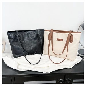 Detail of tote bag showing premium houndstooth embossed texture and stylish dual-color strap