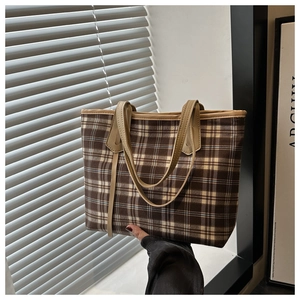 Detail view of the vintage brown plaid tote bag with long synthetic leather handles