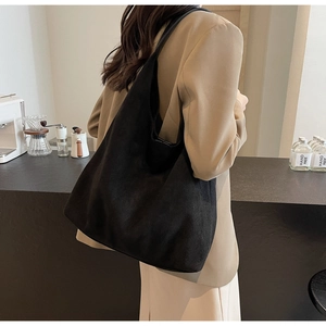 Detail of a black suede Hobo bag showing soft texture and large capacity for commuting