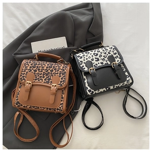 Close-up of brown and black leopard print patchwork backpacks on a stylish background