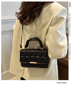 Fashionable black quilted crossbody bag with gold buckle and stylish knotted handle