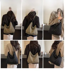 Close-up of olive green and black polka dot tote bags with premium leather handles