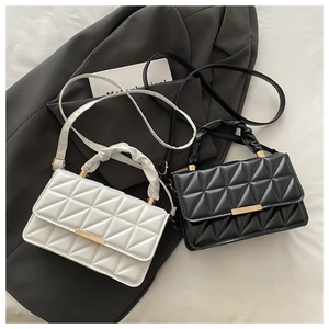 Detail of triangle quilted small crossbody bags in black and white with gold metal buckles