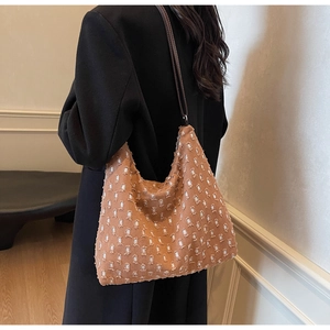 Detail of caramel hobo bag featuring unique distressed texture and slim leather straps