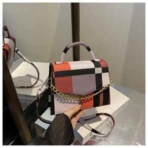 Detail of color-block plaid crossbody bag with gold chain and matching shoulder strap