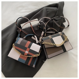 Detail of color-block plaid crossbody bags with decorative gold chains and matching straps