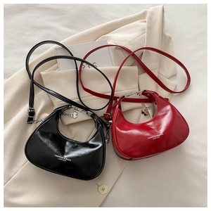 Detail of vintage crescent bags in black and burgundy with leather pleated texture