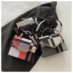 Close-up of color-block plaid square bags with gold chain decor and detachable straps