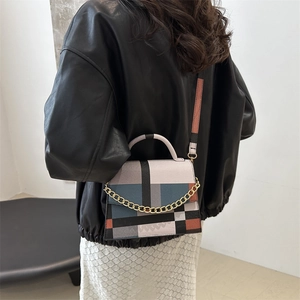 Chic color-block rectangular crossbody bag with gold chain strap on female model