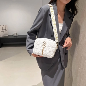 White quilted crossbody bag with gold SSS logo and stylish wide patterned shoulder strap