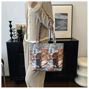 Detailed close-up of a large vintage denim print tote bag shown on model for daily commute