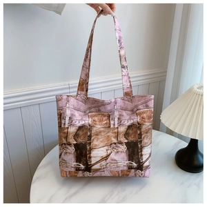 Detail of printed canvas tote bag with vintage denim texture on a marble surface