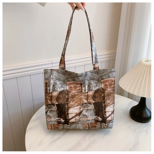 Macro view of vintage denim print on a large tote bag with stitching and pocket details