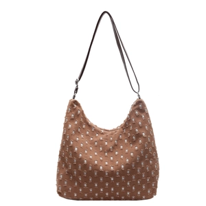 Brown woven polka dot shoulder tote bag with white fringed square patterns and leather strap