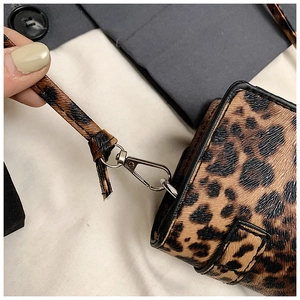 Detail of leopard print bag showing silver metal lobster clasp and stitch texture