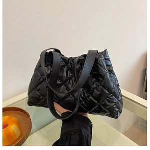 Close-up of black quilted puffer tote bag made of lightweight padded cotton fabric