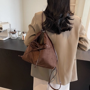 Minimalistische dunkelbraune Wildleder-Beuteltasche mit schicker Schleife und Riemen
