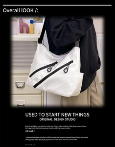 Detail of white nylon tote bag with functional parallel black zipper pockets and wide strap