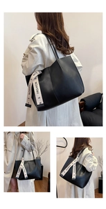 Detail of a black large-capacity tote bag featuring a beige 'FASHION' canvas ribbon strap