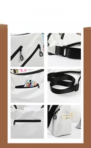 Detail of white nylon tote with black waterproof zippers and wide woven shoulder strap
