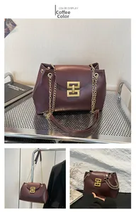 Detail view of coffee brown tote bag with gold hollow buckle and chain strap