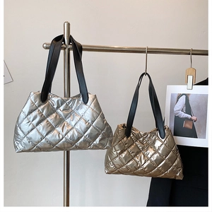 Detailed view of quilted tote bags in metallic silver and bronze with diamond stitching