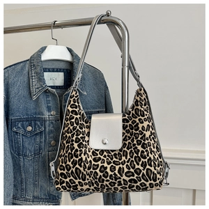Detail of leopard print hobo bag with silver metallic flap and durable canvas texture