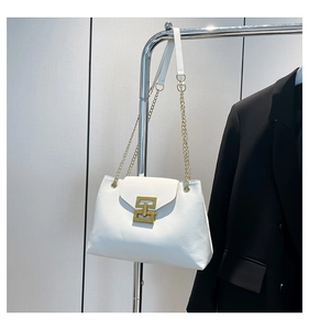 Detail of white leather shoulder bag with gold geometric lock and chain strap