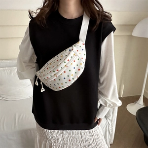Minimalist canvas waist bag with vibrant colorful polka dots and adjustable strap