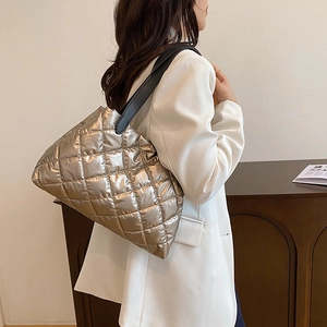 Champagne gold quilted puffer tote bag with elegant metallic finish and long strap