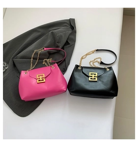 Detailed view of fuchsia and black hobo bags with golden chain straps and square buckles