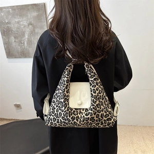 Fashionable leopard print tote bag with white leather flap and minimalist round buckle design