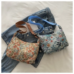 Close-up of floral jacquard tote bags with vintage patterns and textured fabric finish