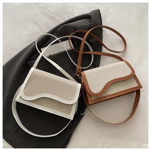 Close-up of contrast-colored PU stitching and wave-shaped flap on elegant crossbody bags