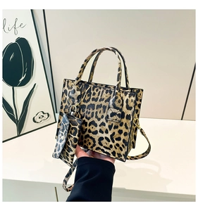 Detail view of leopard print handbag set with mini pouch and gold hardware