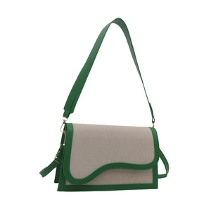 Fashionable contrast color PU shoulder bag with green trim and unique wavy flap design