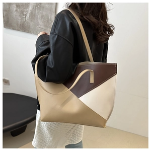 Minimalist tote bag with geometric color-blocking in brown and beige on a female model