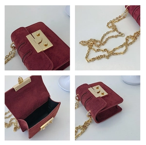 Detail view of burgundy suede mini bag with gold chain strap and metal push-lock closure