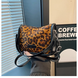 Detail of leopard print shoulder bag with black leather trim and Fashion logo badge