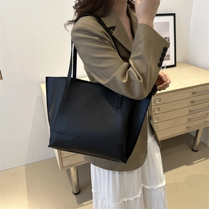 Minimalist black matte leather tote bag for women featuring spacious shoulder strap design