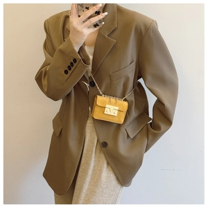 Detailed mirror selfie of a yellow mini suede crossbody bag on a brown blazer suit